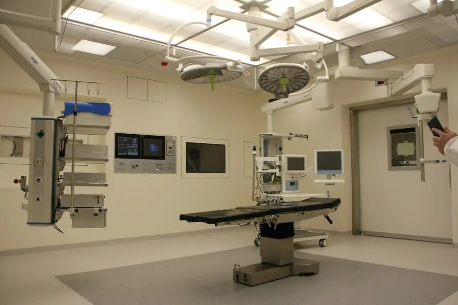 A hospital corridor with staff at a nursing station