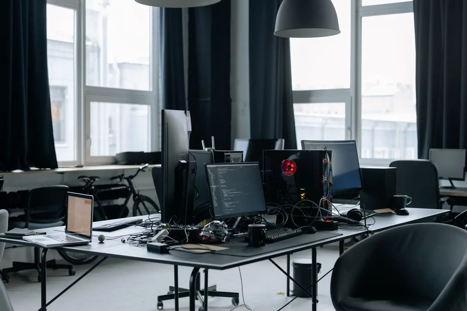 An open-plan office with rows of desks and monitors