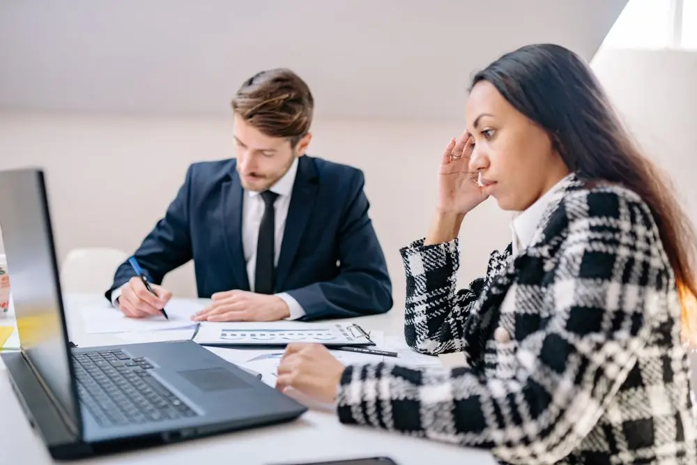 Colleagues reviewing documents together at a desk