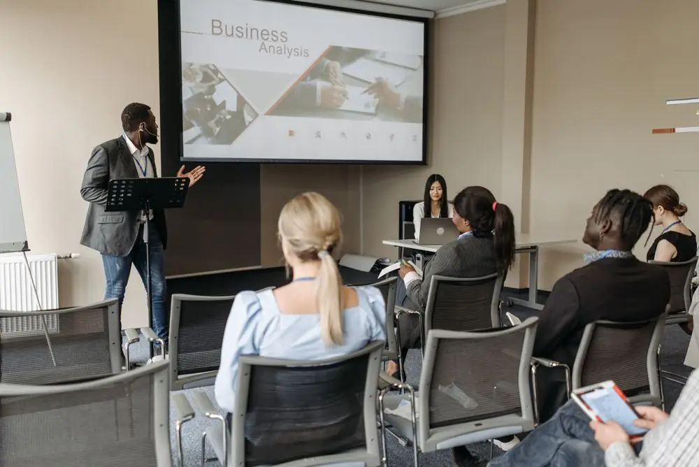 A presenter leading a workshop for a small group